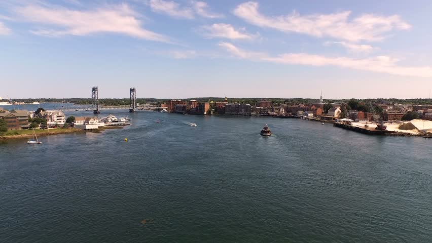 Portsmouth Aerial v4 Flying low over Piscataqua River and harbor panning with city views.