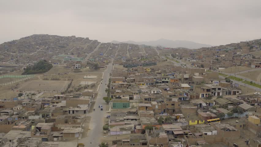 Ventanilla Peru Aerial v1 Flying low over urban poverty hillside housing area.