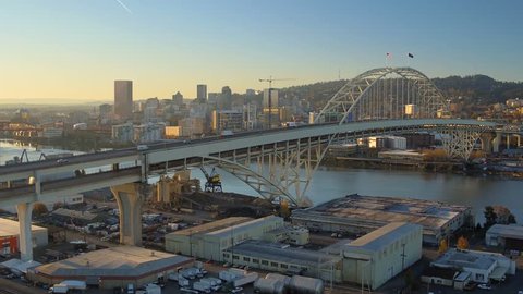 Portland Aerial v63 Flying low over Fremont Bridge panning with cityscape views at sunrise.