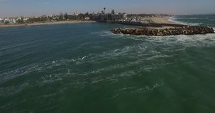 Aerial and bird perspective view from drone of Namibian Atlantic coastline, Swakopmund buildings and beach, surf break point, landscape with ocean background of Swakopmund town at Namibia's west coast