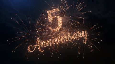 Happy birthday Anniversary 5 years celebration greeting text with particles and sparks on black night sky with colored slow motion fireworks on background, beautiful typography magic design.