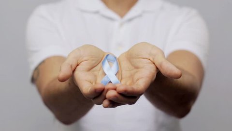 health and people concept - man in t-shirt with blue prostate cancer awareness ribbon