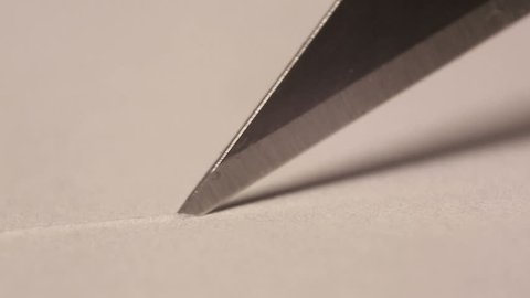 Cutting paper with a craft knife up close
