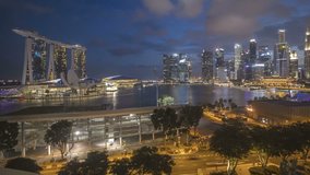 Dusk to Night scene at Marina Bay Singapore Skyline with laser light show. Tilt up