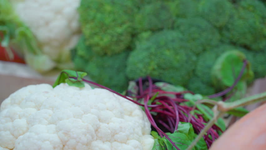 Fresh vegetables on the table in the kitchen. There are cauliflowers broccoli carrots and cabbage on the table Royalty-Free Stock Footage #24182341
