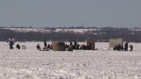Keswick, Ontario, Canada February 2017 People out ice fishing and enjoying frozen lake on sunny winter day