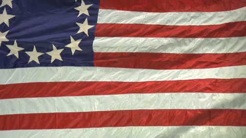 VIRGINIA - OCTOBER 2016 - Patriotic, American Revolutionary War era flag 13-stars, Betsy Ross style.  July 4th red, white & blue, stars and stripes flag against green screen background.  13 Colonies