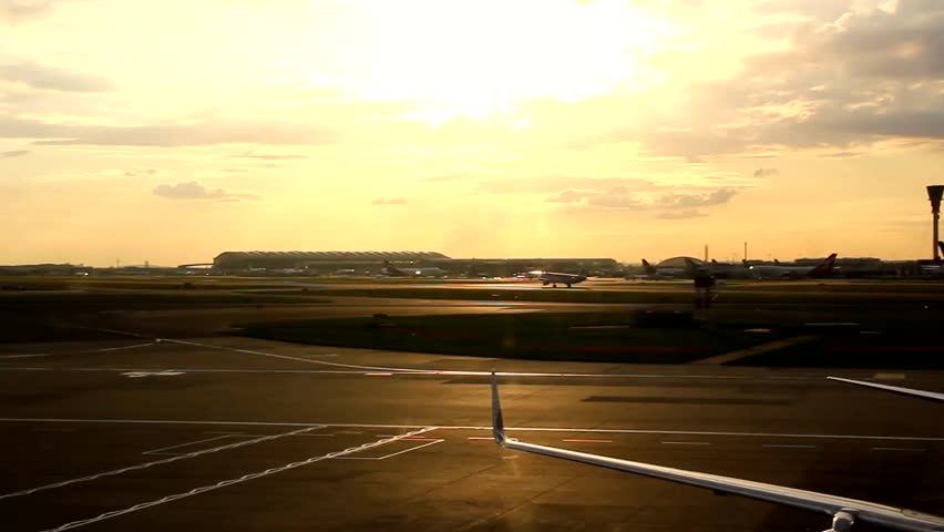 Airplane taking off at sunset from Heathrow airport in London, England Royalty-Free Stock Footage #24184897