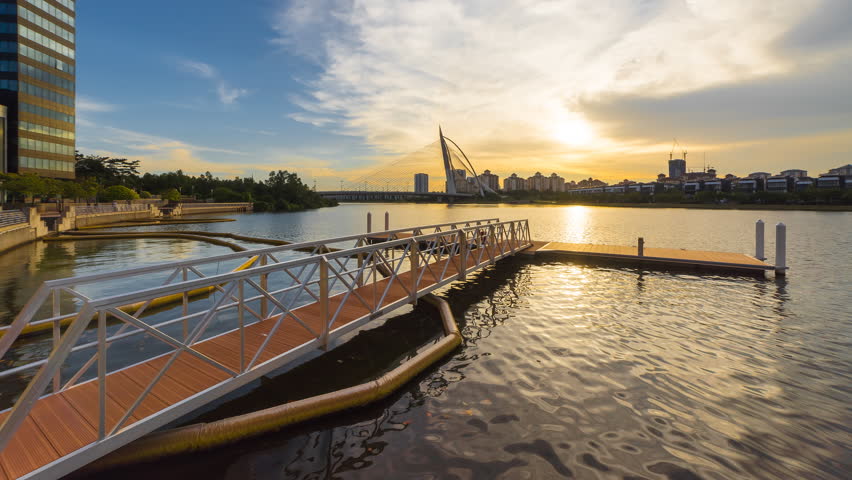 Timelapse of a boat jetty during beautiful sunset in Putrajaya, Malaysia overlooking the Purajaya bridge. Vibrant color, Motion Time lapse Pan Up