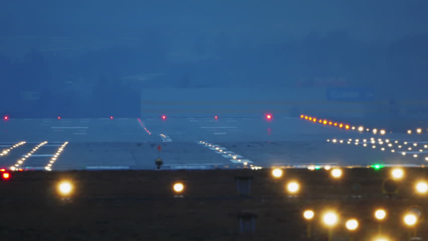 Commercial Jet Airplane Landing in airport runway at dusk, early night.  Royalty-Free Stock Footage #24192205