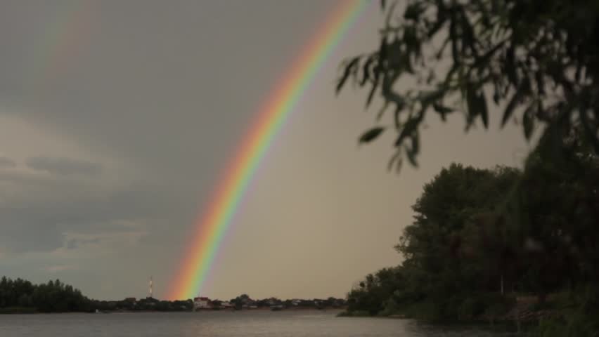Big rainbow after the rain on the river