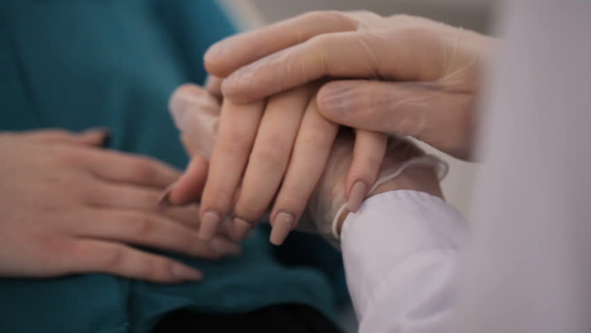 Hand of doctor reassuring her female patient | Shutterstock HD Video #24198604