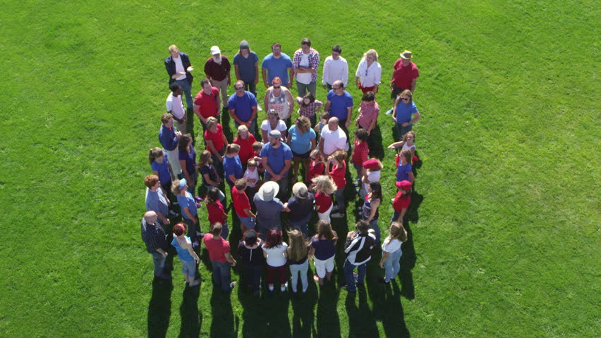 Large group extends their arms towards each other.