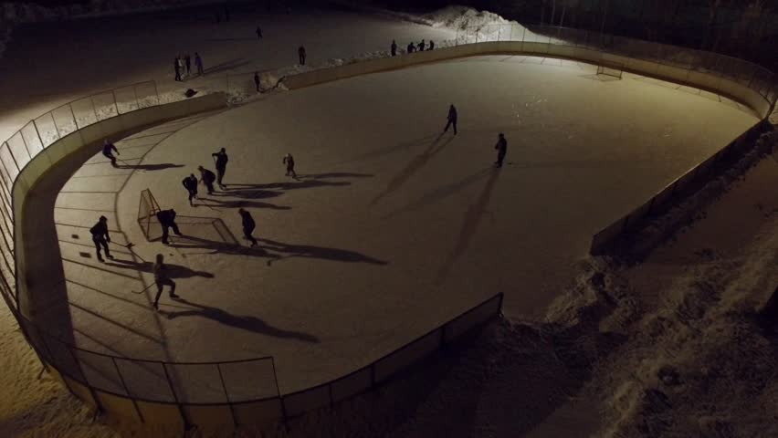 Game going on at a local hockey rink in Finland. Aerial shot.