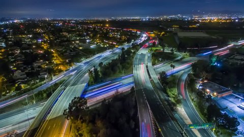 Static aerolapse ( aerial timelapse / hyperlapse ) view of traffic on 405 and 101 freeways interchange at night. Van Nuys, Los Angeles. 4K UHD timelapse background