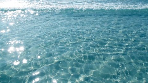 tropical sea beach ripple water turquoise reflections on a white sand bottom