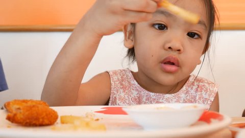 Children with fast food , Asian children to delicious with fast food in restaurant