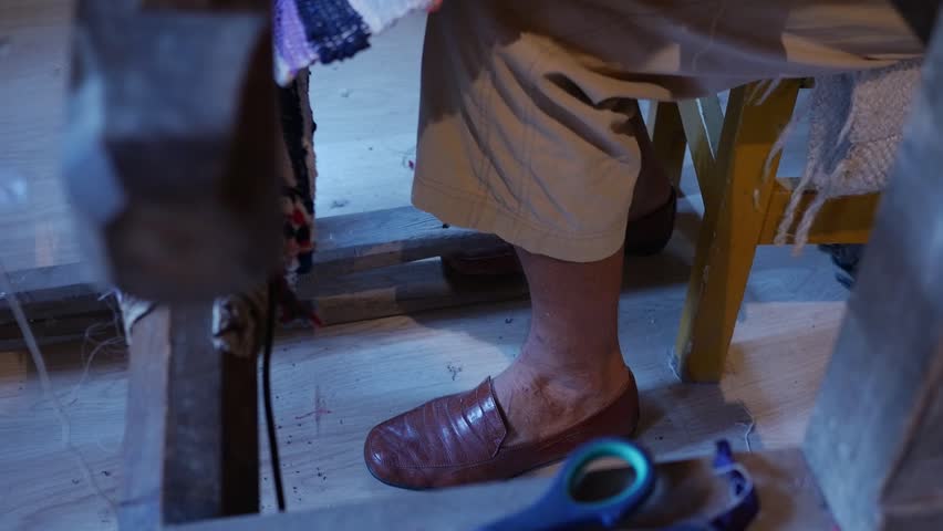 Detail of an old loom a woman who works and make a door mat of rags 15
