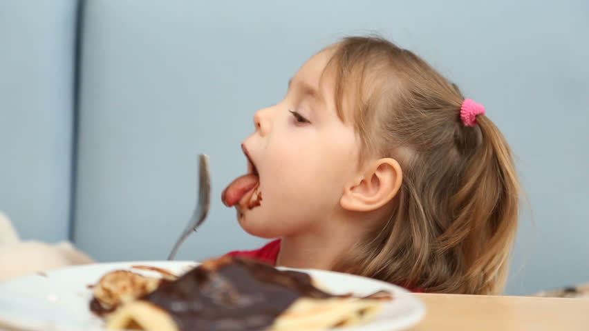 3-4 years old caucasian girl eating pancakes with chocolate. Royalty-Free Stock Footage #24218380