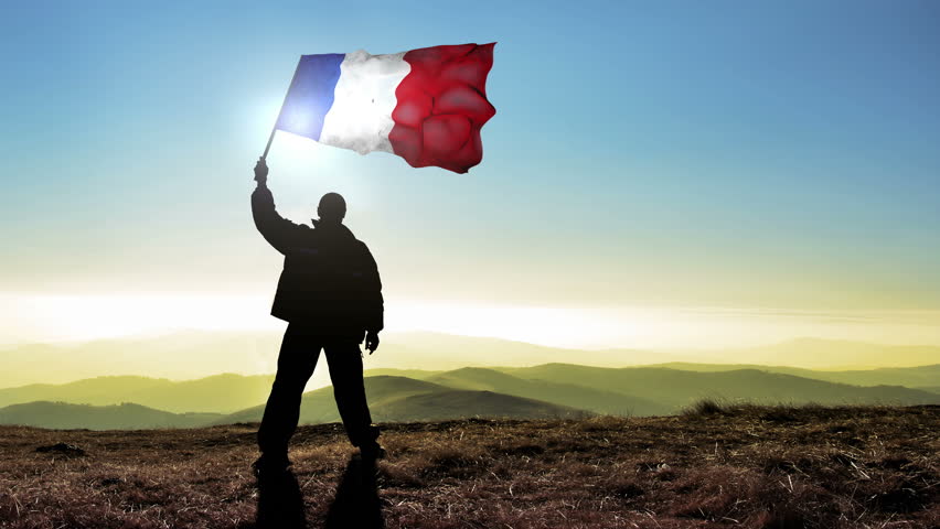 Successful silhouette man winner waving French flag on top of the mountain peak. Cinemagraph LOOP background