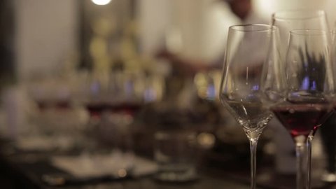 Footage of stylish wine glasses for wine tasting in fine dining winery with wine on table