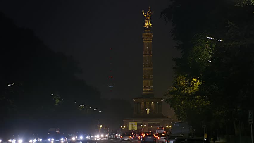Berlin Monument Victory Column at night, light projection Festival of Lights traffic , TV Tower in the background
