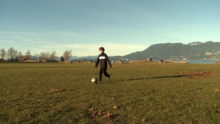 little boy playing soccer