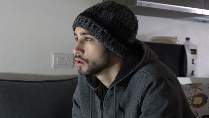 Young Man with hat plays Videogames