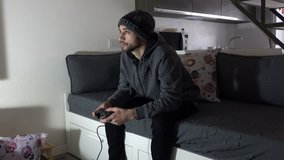 Young Man with hat plays Videogames