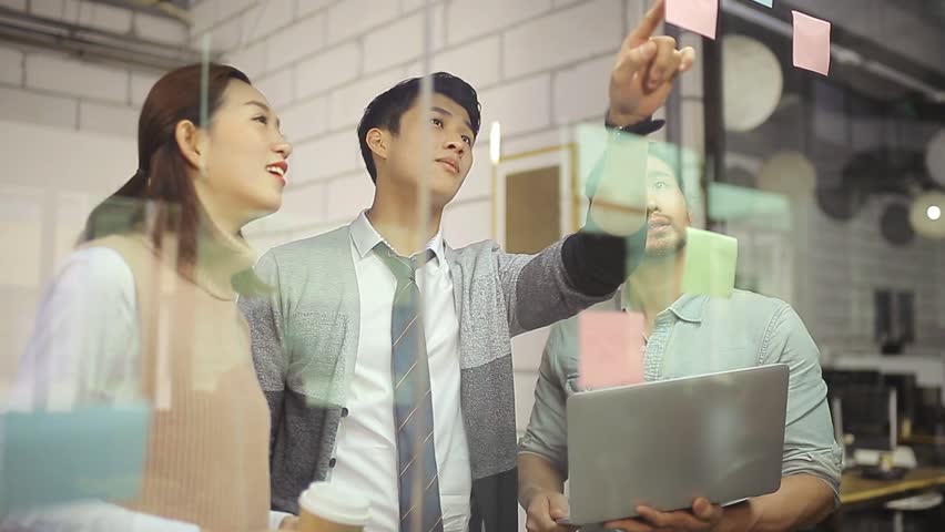 Small group of asian entrepreneurs discussing business strategies using sticky note in office meeting room.  | Shutterstock HD Video #24243989
