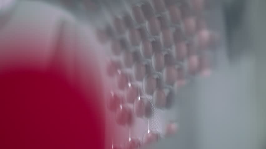 Automated packing at drug production. Closeup slow motion shot of an automated pill packaging machine.Tablets in Packages on a Conveyor. Pharmaceutical machinery for medicine production Pills. Royalty-Free Stock Footage #24244037