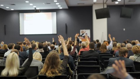Business people Raising there Hand Up at a Conference to answer a question 4k.
