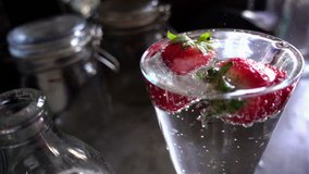Strawberries floating on soda water, HD slow motion