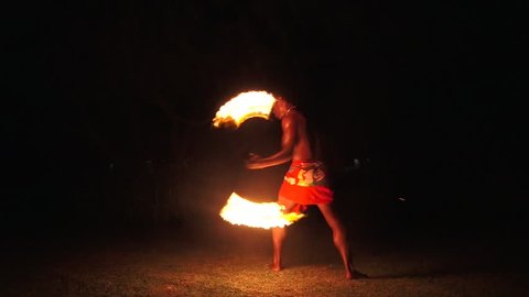 Indigenous Fijian man during during a fire dance at nigh in Fiji. Real people copy space