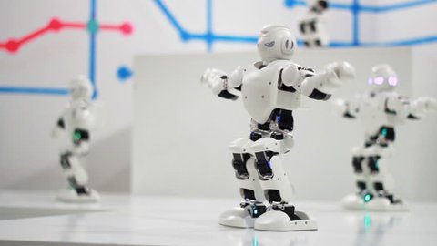 Humanoid robot dance. Group of cute robots dancing. Close up of smart robot dance show. Dancing robot performance. Robotic dance party. Smart robotic technology