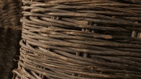 Tilting on interwined ancient wicker basket 4K 2160p 30fps UltraHD footage - Old coiled container details and texture shallow DOF 3840X2160 UHD video