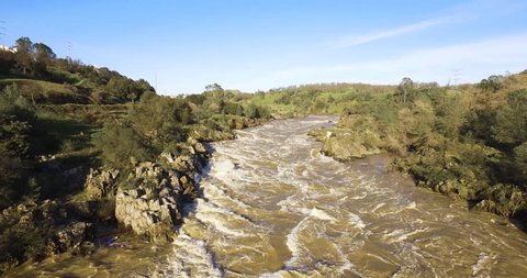 4k Raging American river during floods in 2017, white water on the American river in Northern California, and people watching from a bridge
