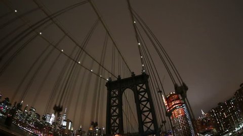 Driving POV on the Brookyln Bridge at night financial district New York City