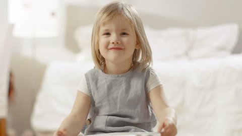 Cute Young Girl Shows Her Drawing of a Family. Shot on RED EPIC-W 8K Helium Cinema Camera.