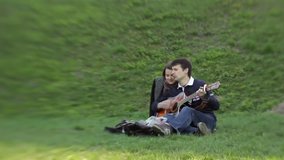 Two people in love are enjoying the sound of a guitar