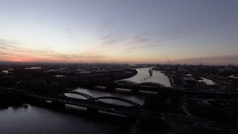 Atmospheric aerial shot of the river Elbe and harbor of Hamburg. Shot in the evening with beautiful light. View of the skyline of Hamburg.