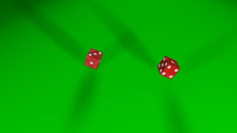 Two rolling red dices falling on green table