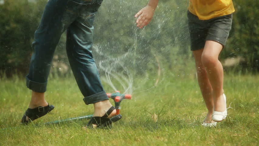 kids playing in sprinkler