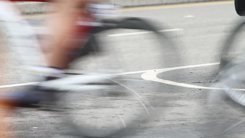 Bicycles race pass by in a blur
