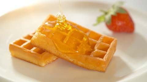 Baked golden waffle and sweet honey