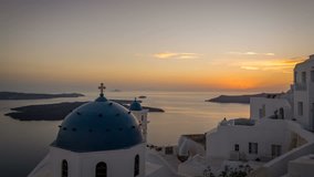 4k Time lapse of the sun setting over the famous blue dome churches in Imerovigli, Santorini.