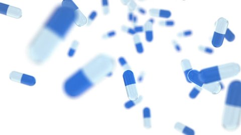 Blue pills falling on white background 