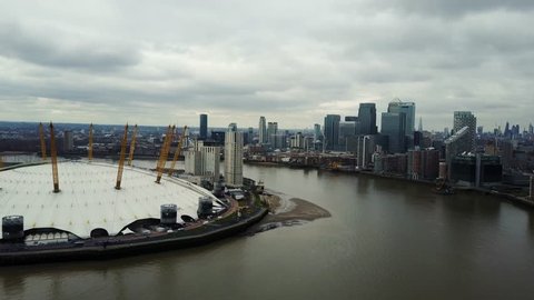 Aerial/Drone footage of the London's O2 arena (Millenium dome) and the river Thames. (4K)