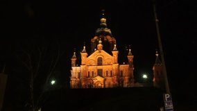 Zooming timelapse of people sightseeing Uspenski Cathedral, at a dark evening night, in Helsinki, Finland.