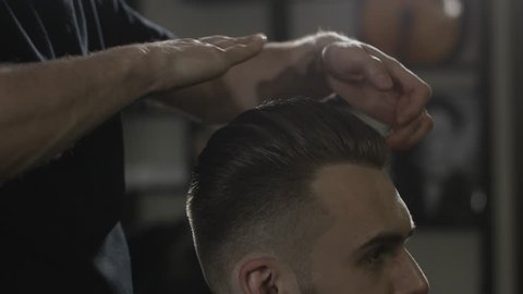 Men's hairstyling in a barbershop or hair salon.